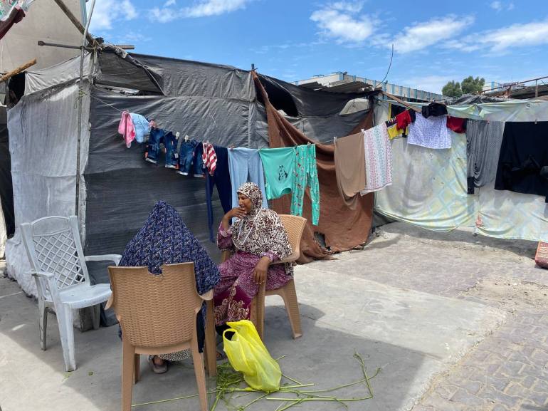 Sœurs s’occupant des tâches dans les allées des tentes pour échapper à la chaleur intense à l'intérieur