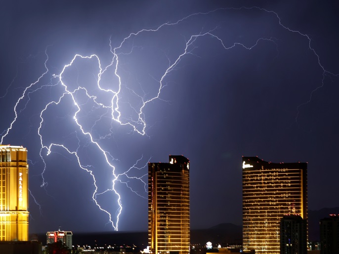 Lightning strikes behind Las Vegas Strip casinos as a thunderstorm passes through Las Vegas