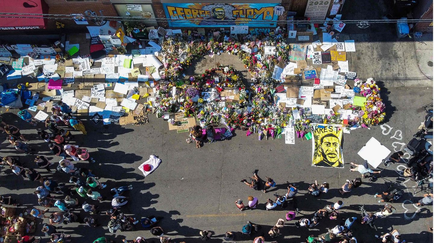 En mémoire des victimes de violences policières, des gens se rassemblent autour d'un mémorial pour George Floyd