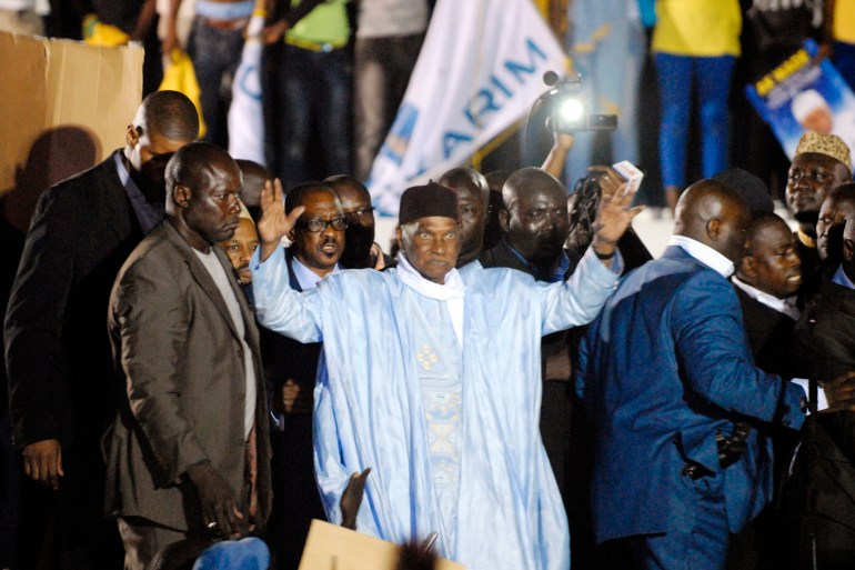 Abdoulaye Wade greets a crowd upon his arrival in Dakar April 26, 2014.
