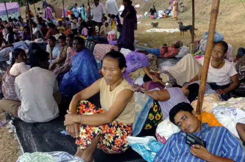 Indian villagers rest at a relief camp in Port Blair