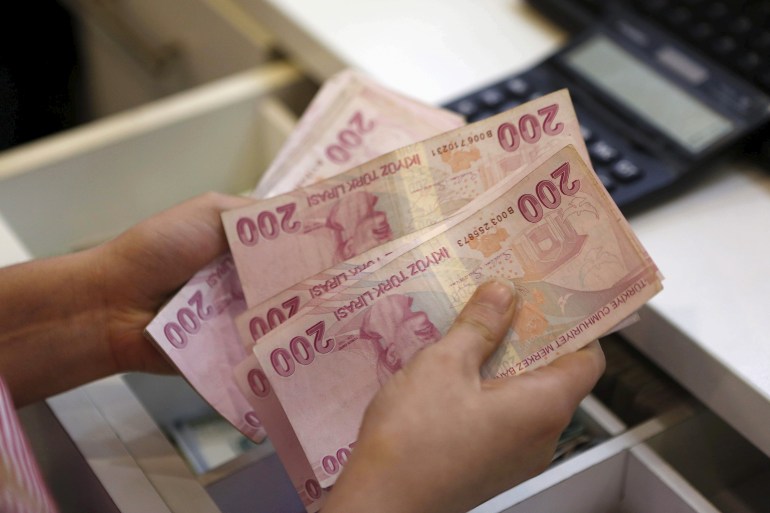 Un changeur de monnaie compte des billets de lira turque à Istanbul