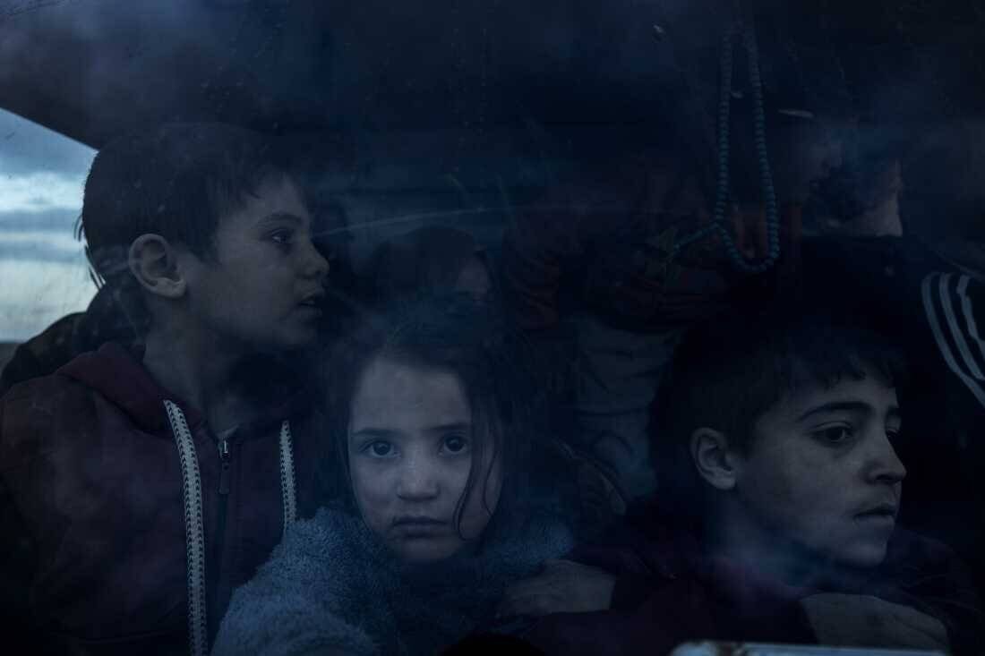 A group of Syrian children with their parents return home in the cabin of a truck, after more than eight years taking shelter in the Rukban camp for displaced people in al-Tanf, Syria, near the border with Jordan, Dec. 14.
