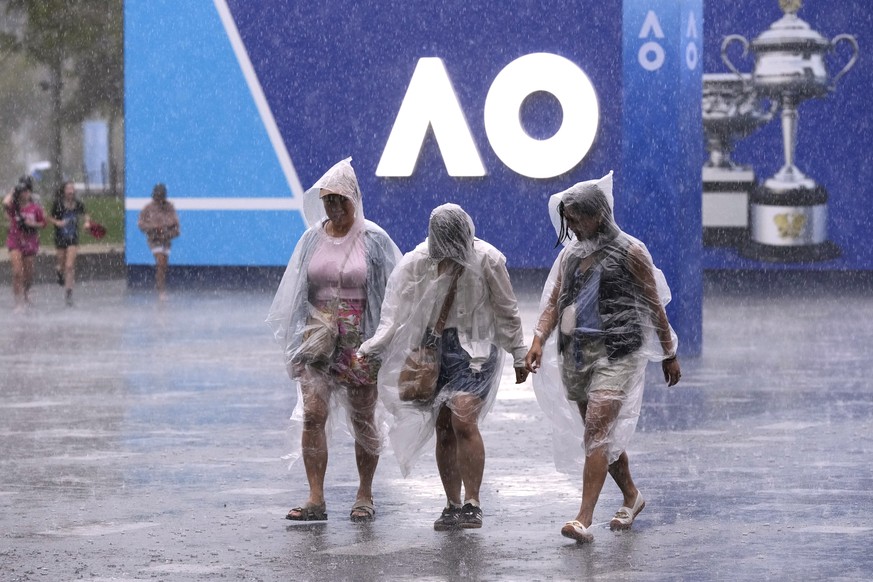 Les spectateurs sous la pluie pendant que les matchs sont suspendus lors du premier tour de l'Australian Open