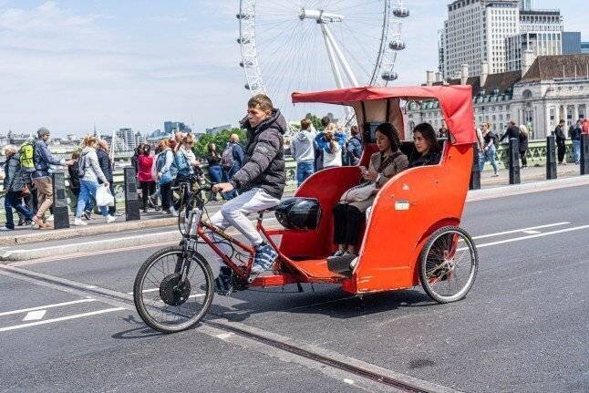 Un rickshaw transportant des touristes sur Westminster Bridge lors d'un week-end ensoleillé. Londres, Royaume-Uni - 04 juin 2022