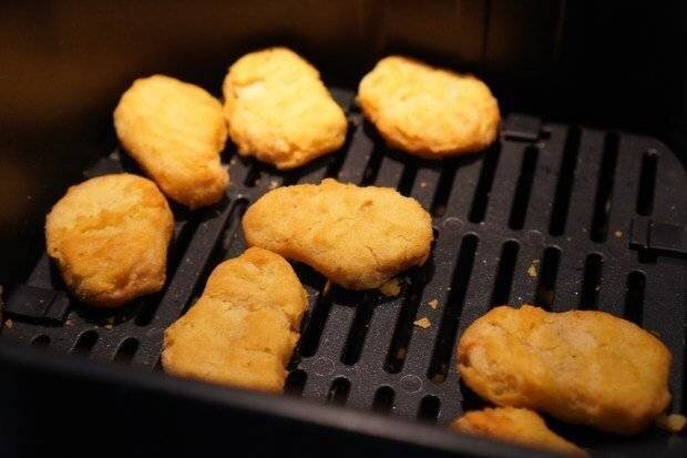 Chicken nuggets in an air fryer.