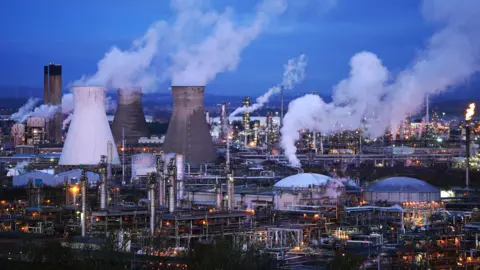 Chimneys and pipes at the Grangemouth plant illuminated by lights