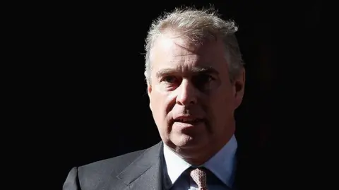 Prince Andrew wearing a suit against a black background