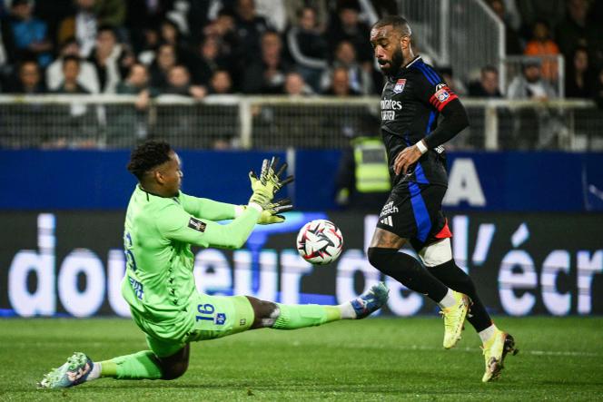 Le gardien d’Auxerre, Donovan Léon, devant l’attaquant lyonnais Alexandre Lacazette, dimanche 13 avril 2025, à Auxerre.