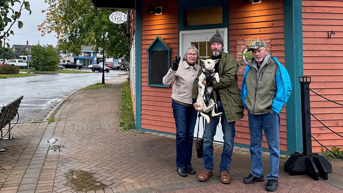 Tom Green avec ses parents tenant son chien Charley.