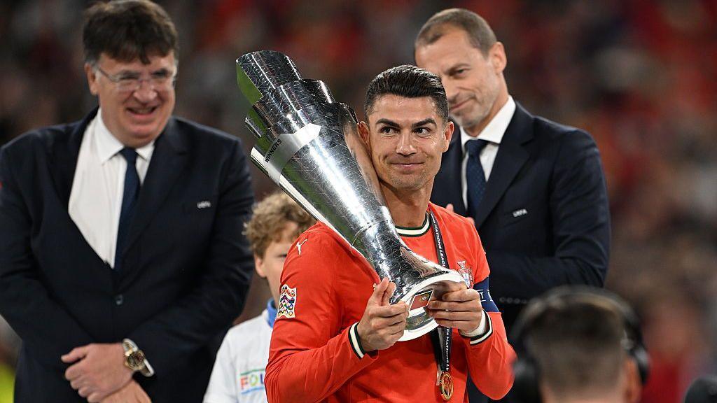 Cristiano Ronaldo hold the nations League trophy