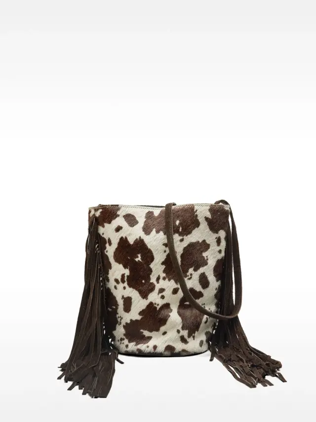 Sac bomboniera en cuir à franges et imprimé vache