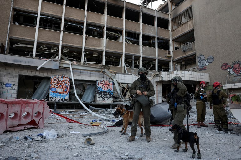 Personnel de secours avec des chiens sur un site d'impact à Haïfa après l'attaque iranienne