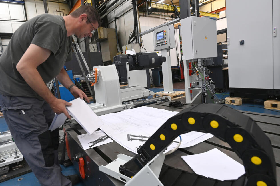 Un employé assemble une machine entièrement conçue par le bureau d'études de l'usine Redex, avant son expédition, à Ferrières-en-Gâtinais, le 18 juin 2025 dans le Loiret