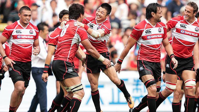 Japan celebrate victory against Wales in 2013