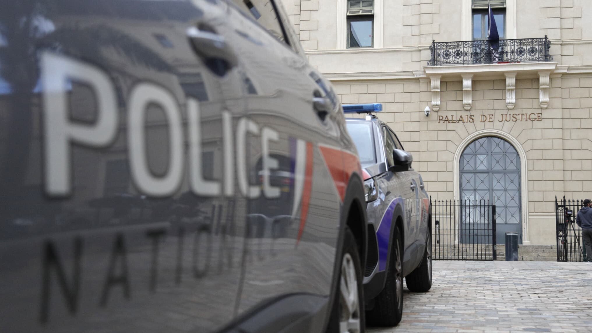 Voiture de police devant un palais de justice