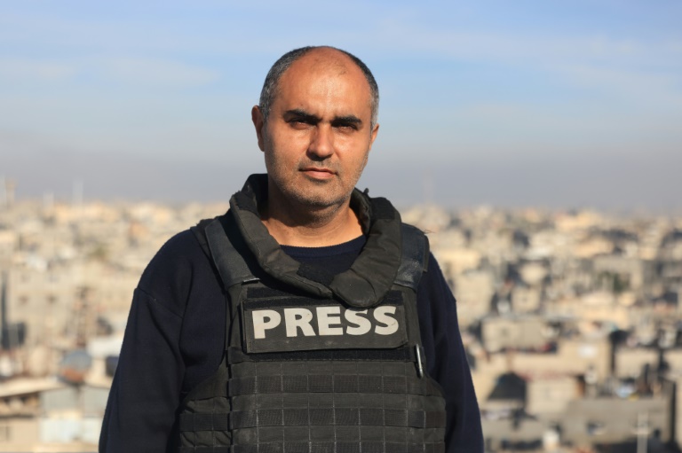 Journaliste couvrant la situation à Gaza avec la chaleur et les ruines en arrière-plan