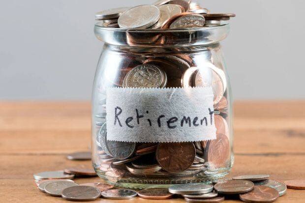 Bocal en verre rempli de pièces étiqueté 'Retraite'