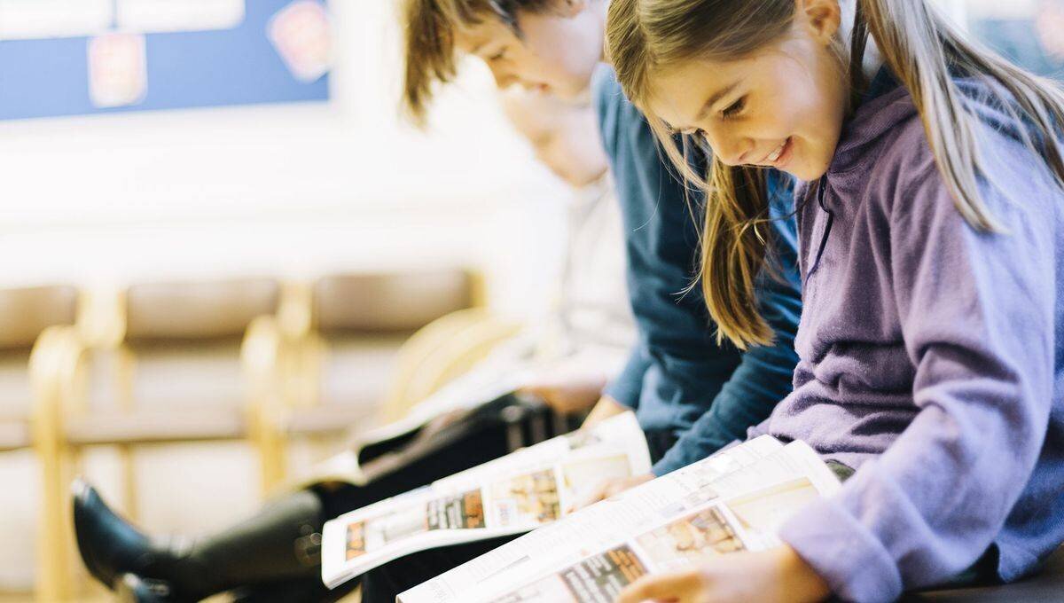 Enfants lisant des BD et albums jeunesse