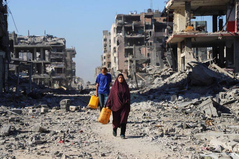 Palestiniens marchant parmi les décombres à Gaza