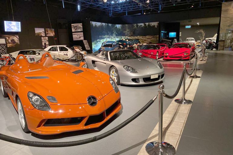 Intérieur du musée montrant des voitures anciennes et une machine à café robotisée